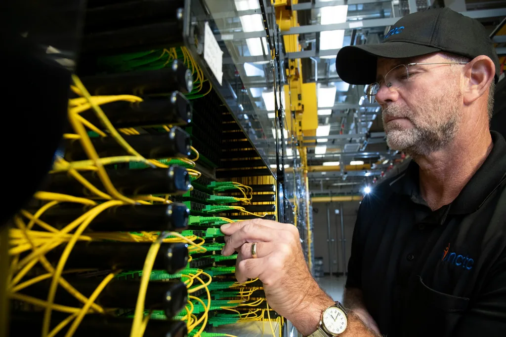 A technician working at a fiber optic distribution frame