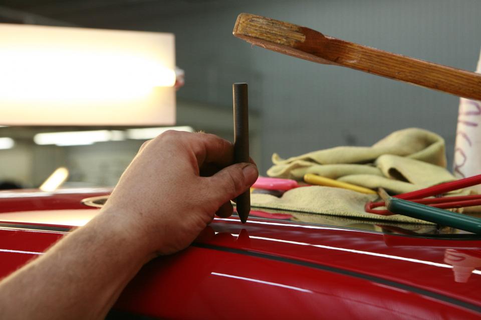 Bodywork being carried out on a car in a repair shop