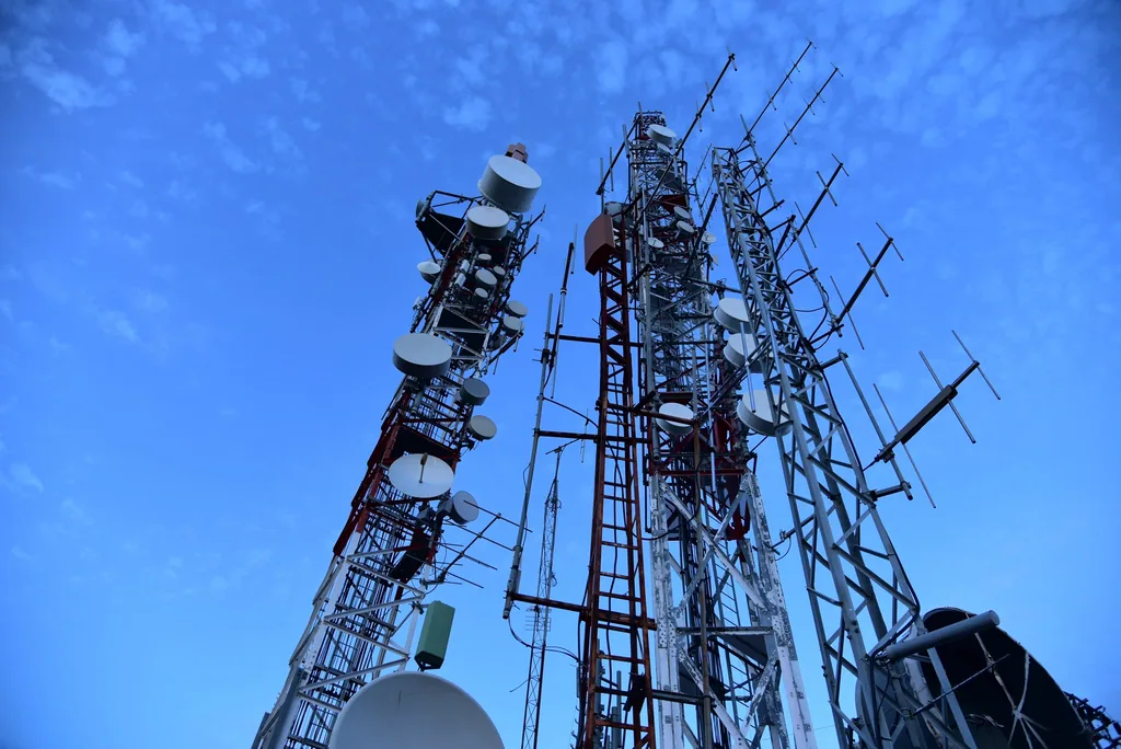 Communication towers carrying microwave dishes and antennas
